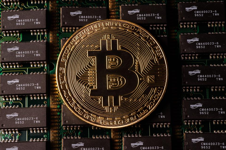 This photo is an illustration of bitcoin, a cryptocurrency, against some hardware.