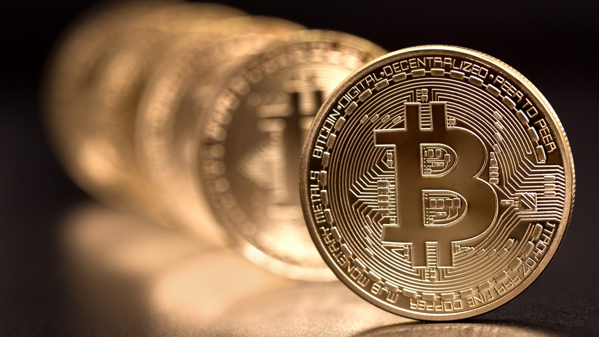 Sofia, Bulgaria - April 24, 2014: Studio shot of bitcoin in a row on black background .